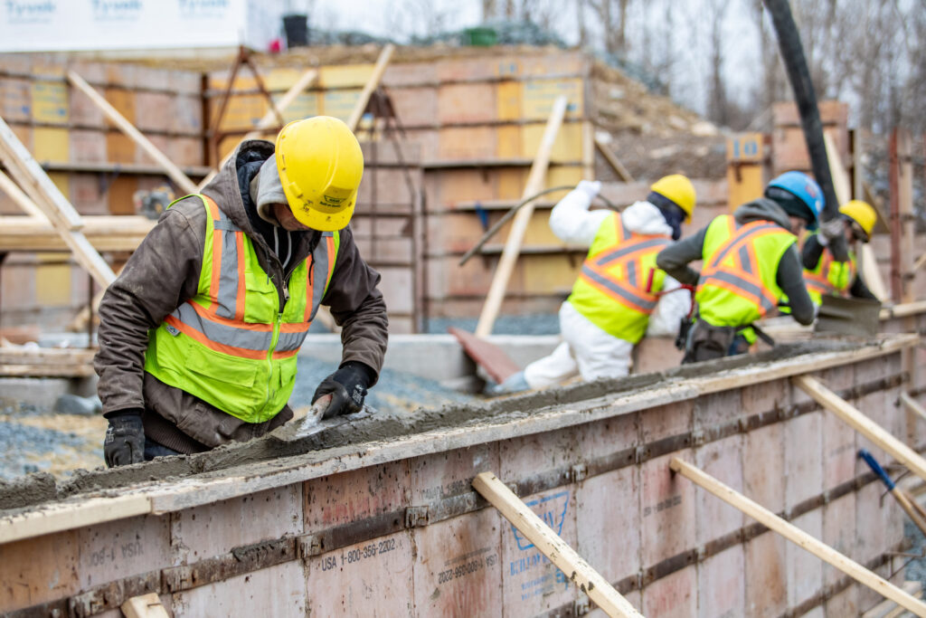 Workers mortar a foundation mould
